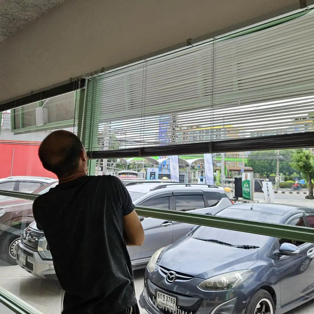 Technician checking installed blinds