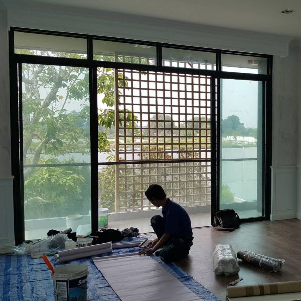 Technician installing wallpaper on-site