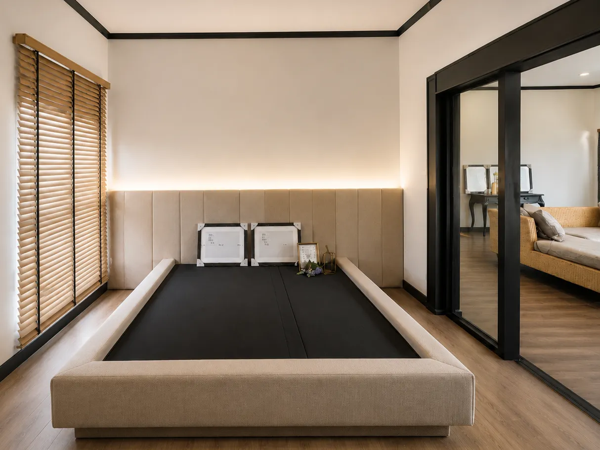 Bedroom with wood venetian blinds on a tall window beside a low upholstered platform bed and mirrored sliding door
