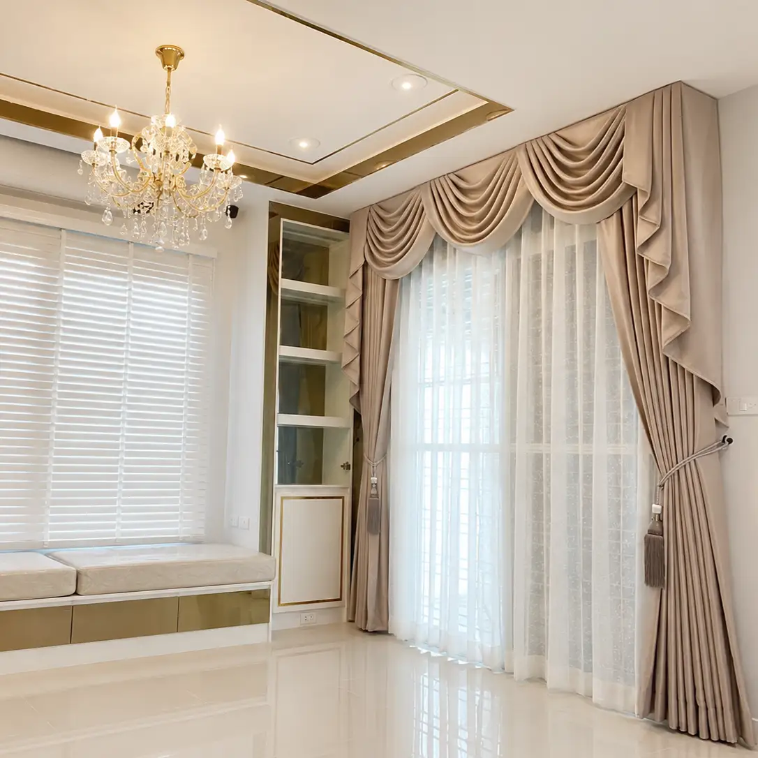 Window seat with white wood blinds and a built-in display shelf, beige swag valance curtain on the adjoining glass door