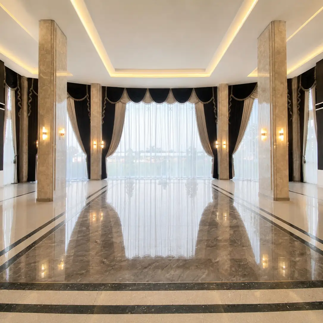 Grand marble hall with black and gold swag valance curtains on floor-to-ceiling windows along both sides