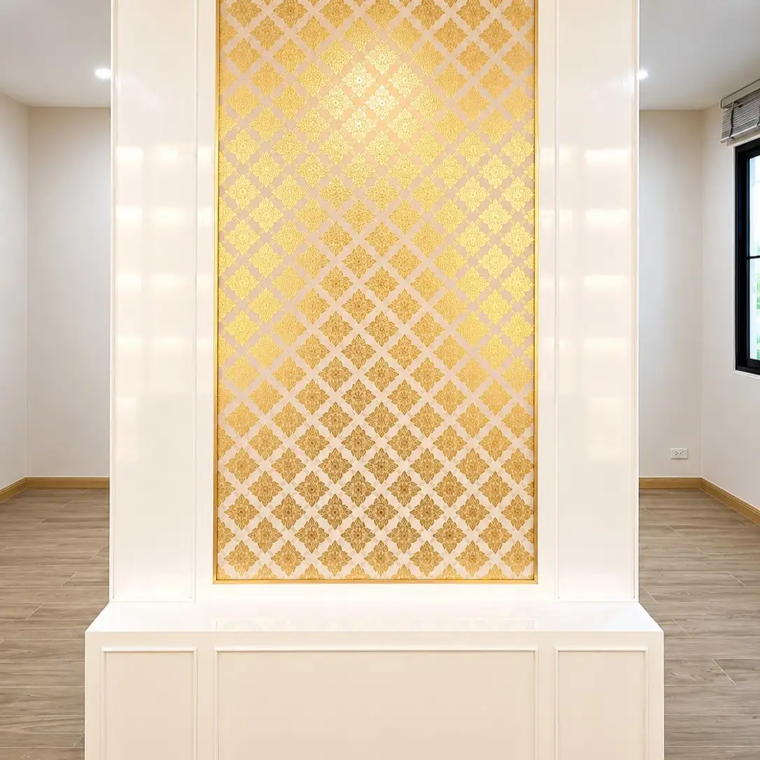 Gold Thai floral lattice wallpaper panel framed in a white hallway alcove with wood flooring