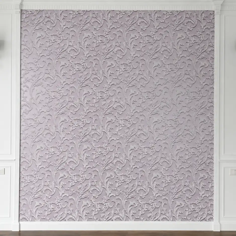 Textured pink damask wallpaper panel framed by white wall molding