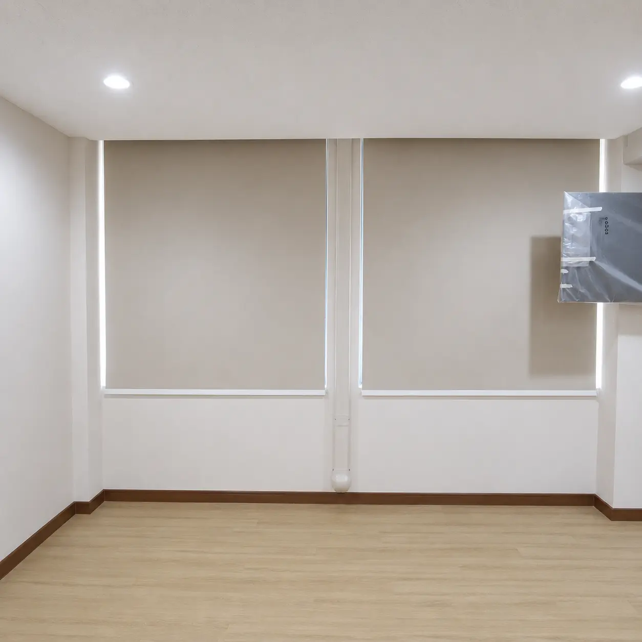 Two fully closed roller blinds side by side on interior windows