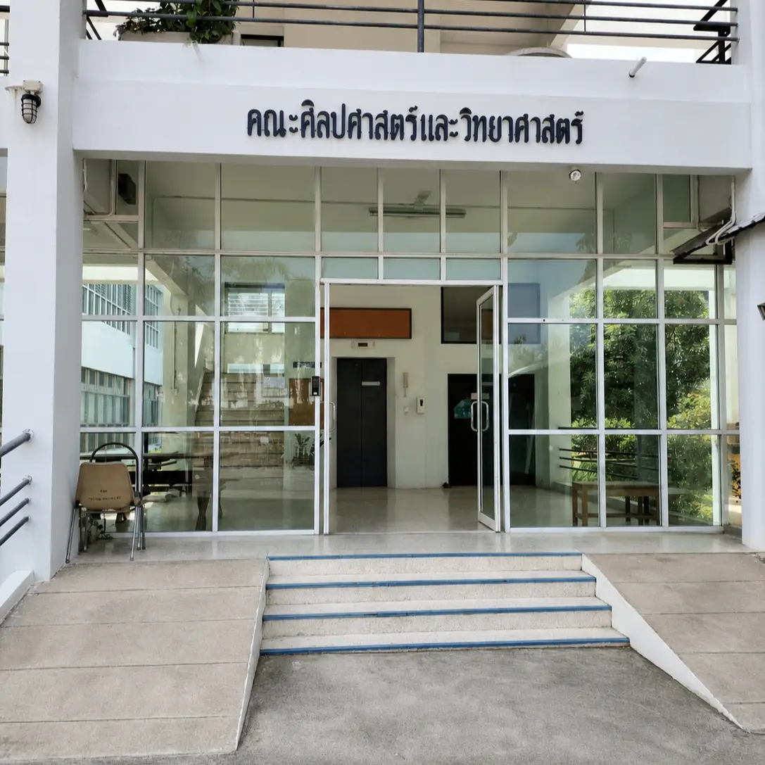 University building entrance with a Faculty of Liberal Arts and Science sign above the glass doors