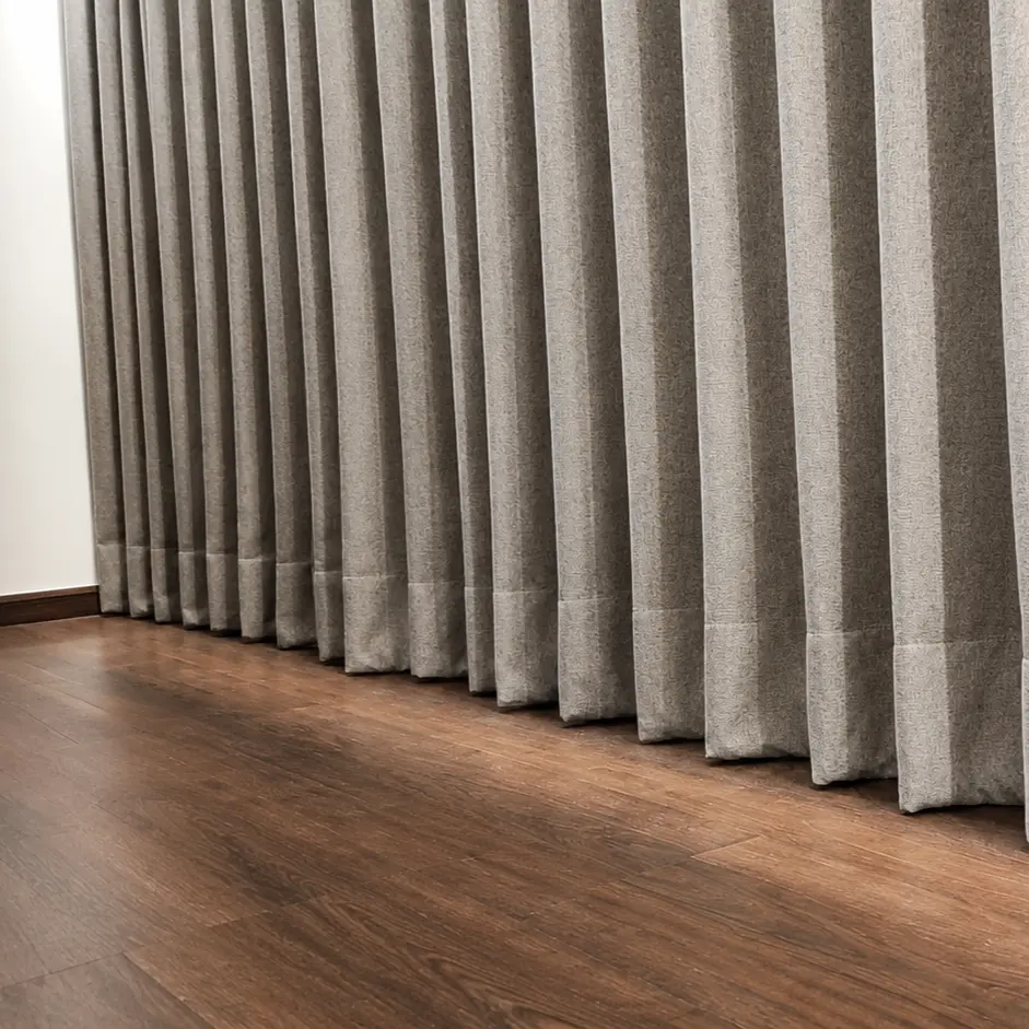 Close-up of pleated wave-fold curtain fabric in a treatment room