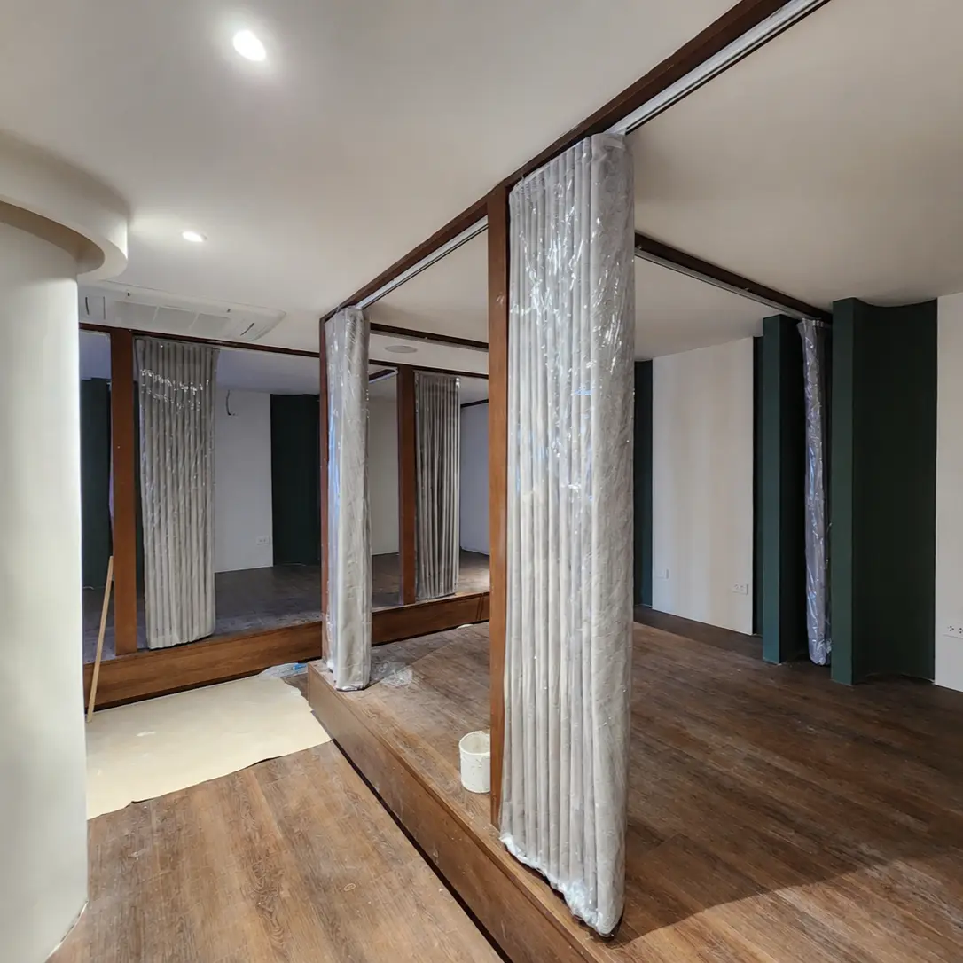 Curtain room dividers still wrapped in protective plastic during installation